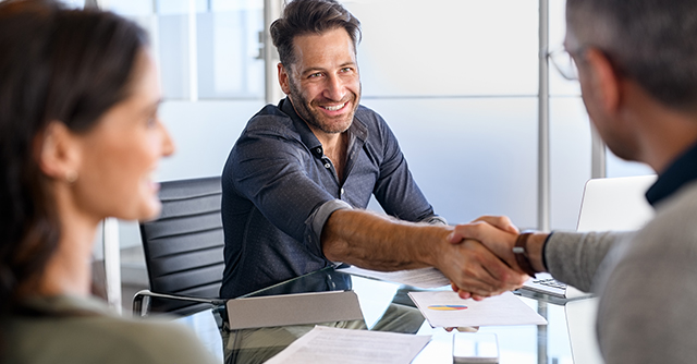 Man shaking hands with banking personel