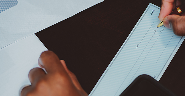 Person writing a check