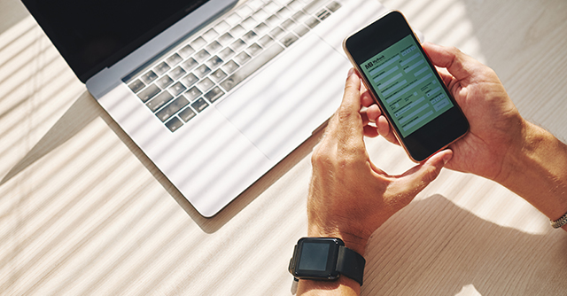 Man holding cellphone and banking online