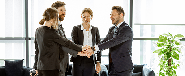Couple shaking hands with bank personel